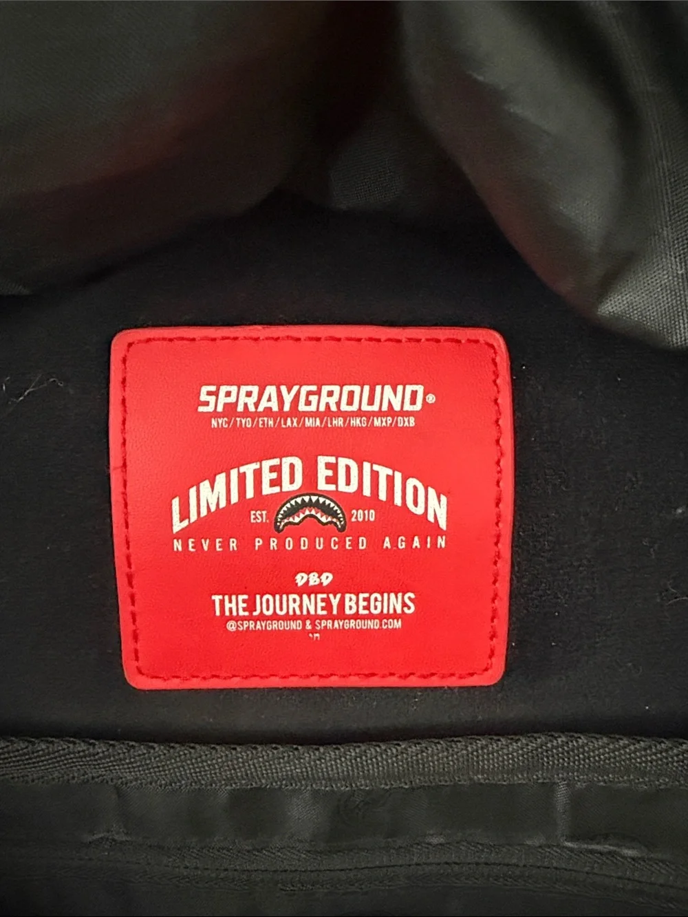 Sprayground Brown Checkerboard Backpack with Red & White Shark Mouth